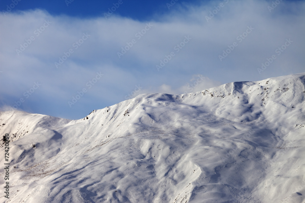 View on off-piste slope in wind morning