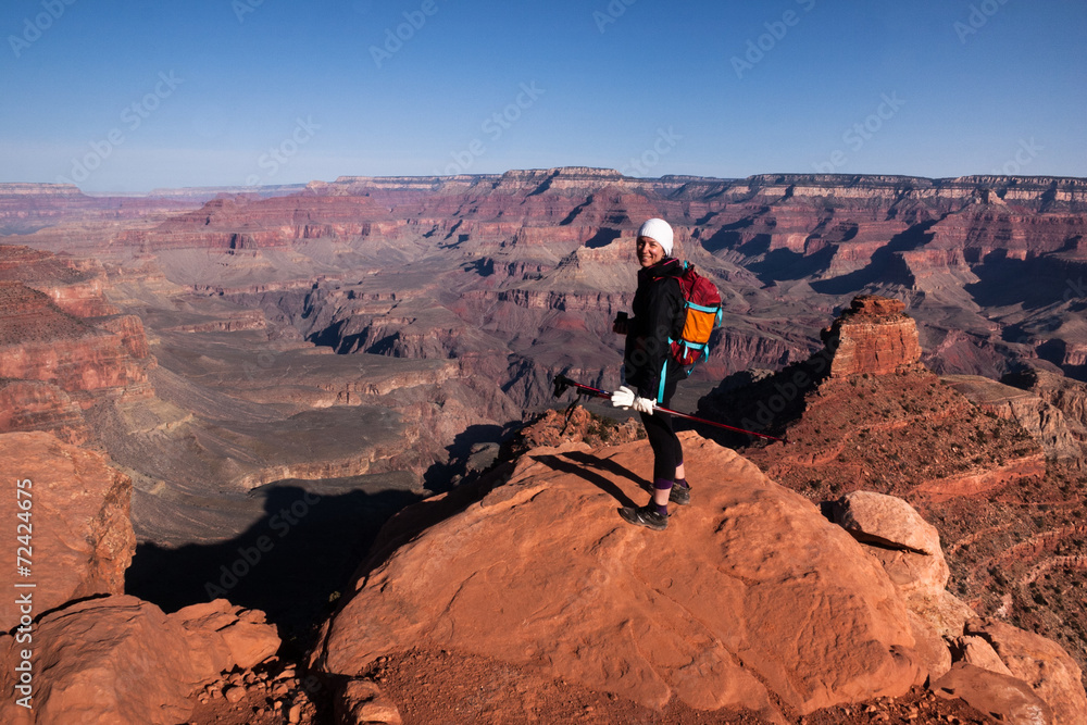 Fototapeta premium One female hiker standing at a cliff in Grand Canyon