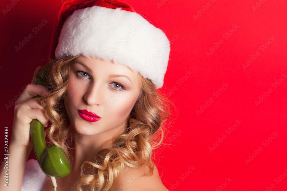 beautiful young woman wearing Santa Claus costume holding green beautiful young woman wearing Santa Claus costume holding green