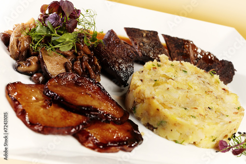 Deer meat with grilled pear, musrooms and mashed potatoes photo