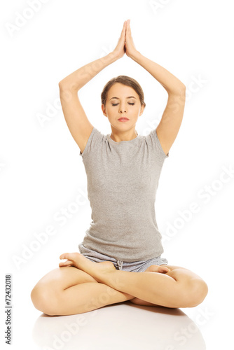 Woman relaxing by yoga © Piotr Marcinski