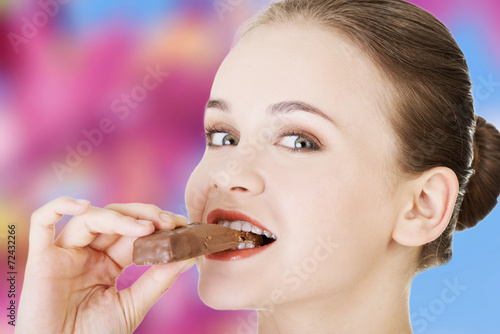 Happy woman eating chocolate waffle