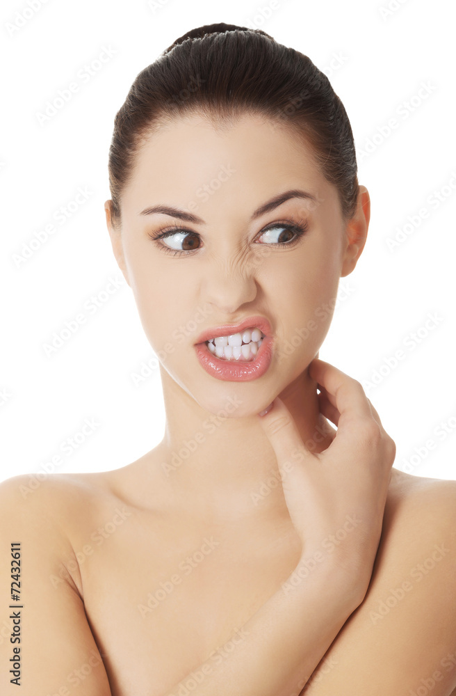 Young beautiful woman scraching her neck Young beautiful woman scraching her neck