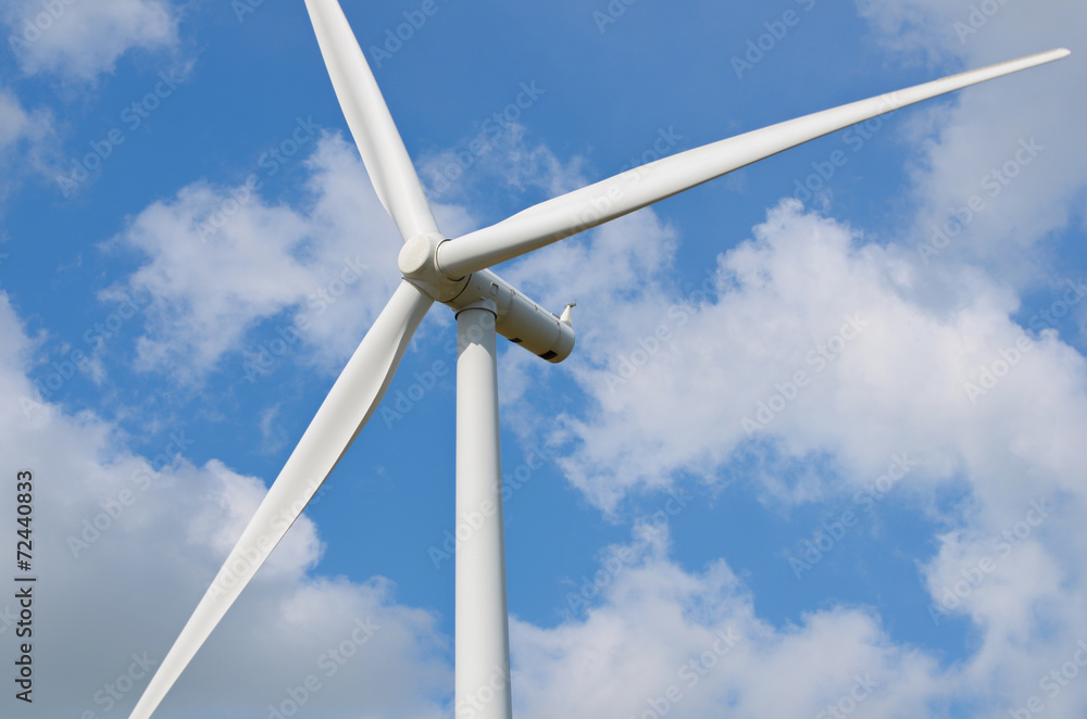 wind turbine against cloudy blue sky background wind turbine against cloudy blue sky background