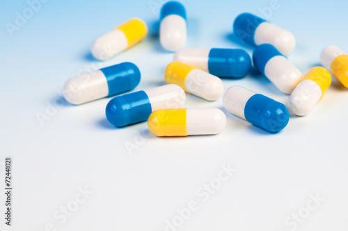 Colorful medical capsules on white background...