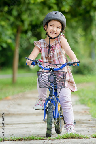 Little Asian child with bicycle