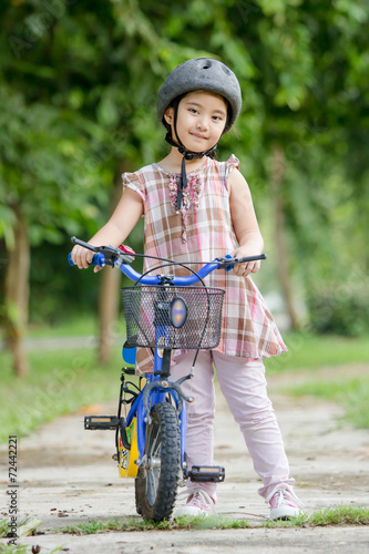 Little Asian child with bicycle