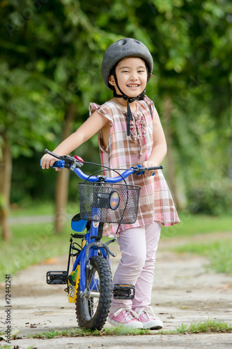 Fototapeta Naklejka Na Ścianę i Meble -  Little Asian child with bicycle