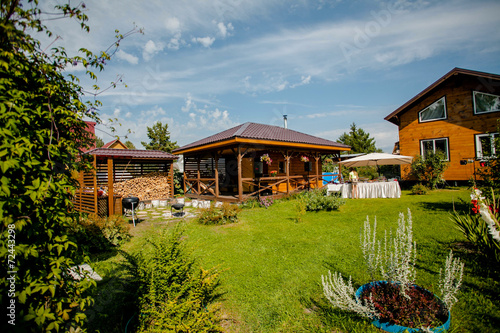 Bild auf Leinwand Cozy wooden house in the coniferous forest