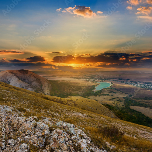 sunset over a dry hills © Yuriy Kulik