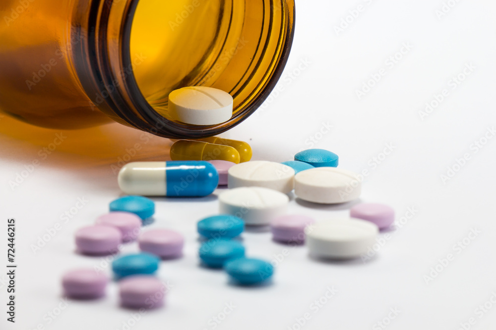 Diferent tablets pills heap mix on white isolated background Diferent tablets pills heap mix on white isolated background