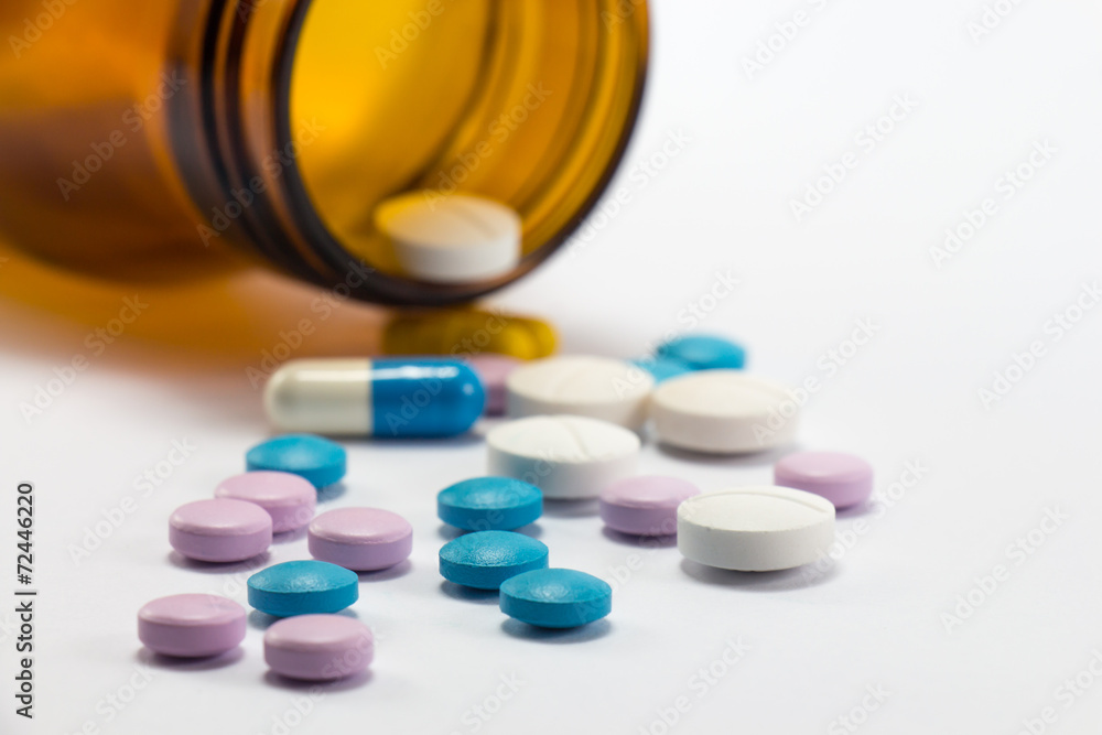 Diferent tablets pills heap mix on white isolated background Diferent tablets pills heap mix on white isolated background