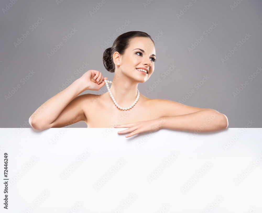 Portrait of a beautiful and healthy woman in a pearl necklace Portrait of a beautiful and healthy woman in a pearl necklace