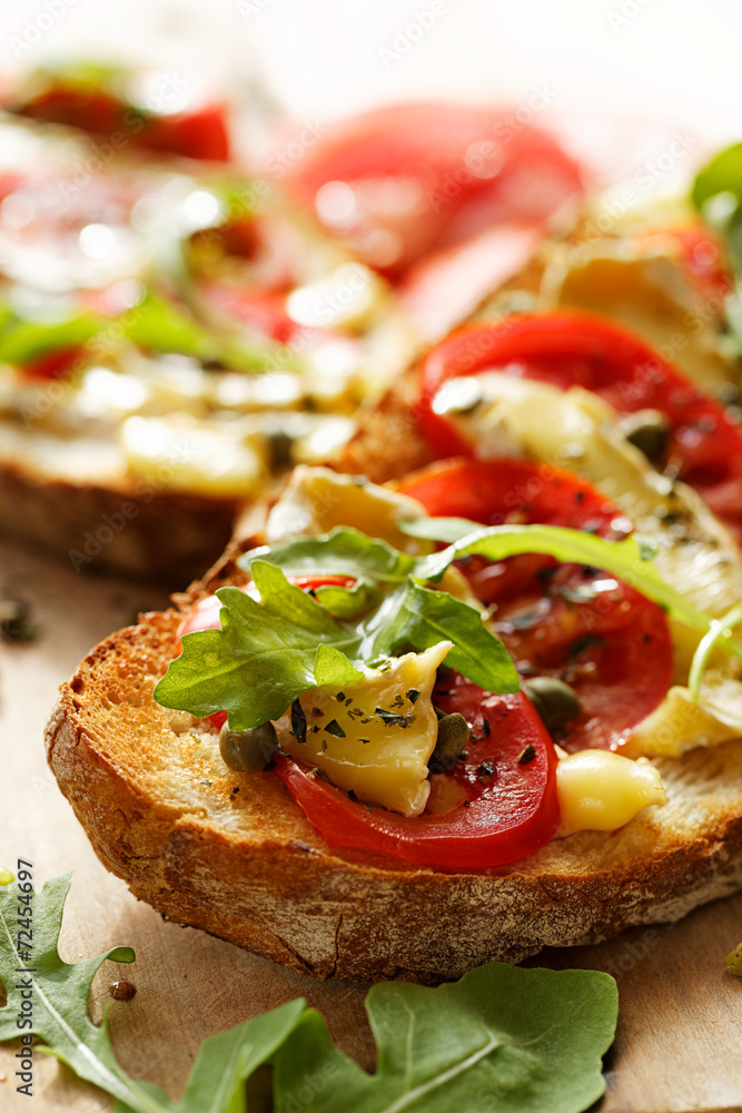 Bruschetta with tomatoes, brie cheese and arugula Bruschetta with tomatoes, brie cheese and arugula