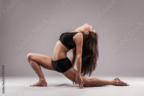 Sporty woman is doing stretching exercise