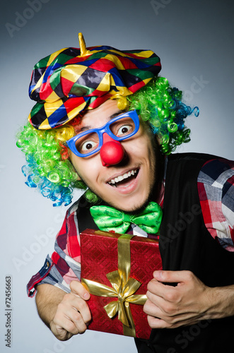 Funny clown with red giftbox