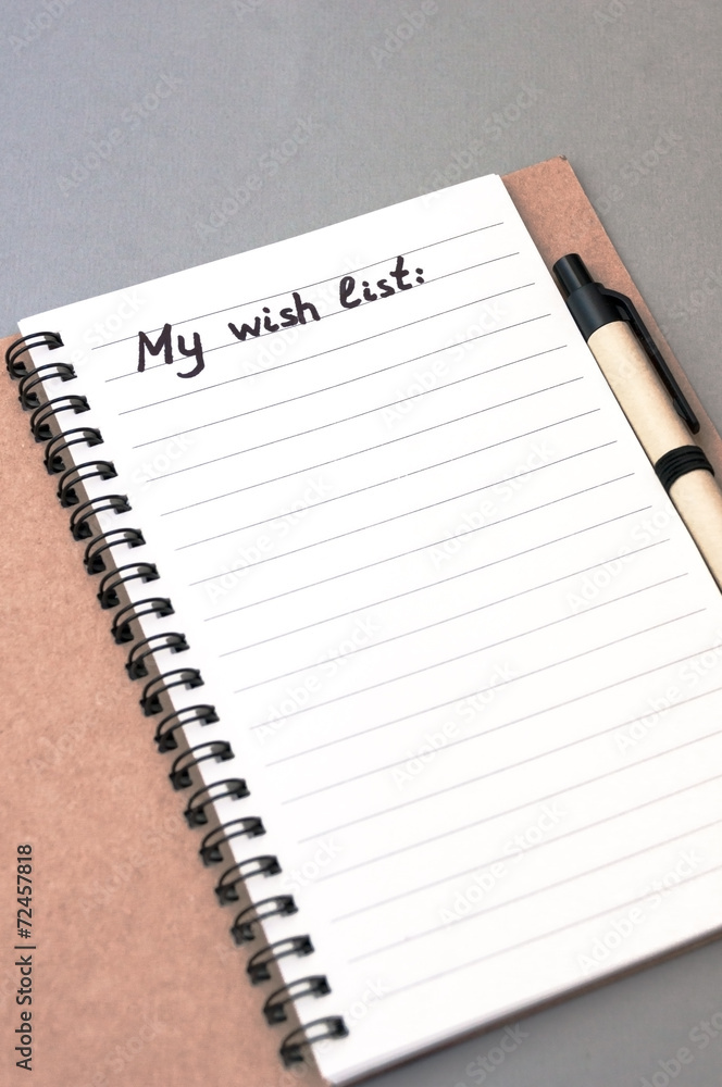 Hand drawing wish list on notebook Hand drawing wish list on notebook
