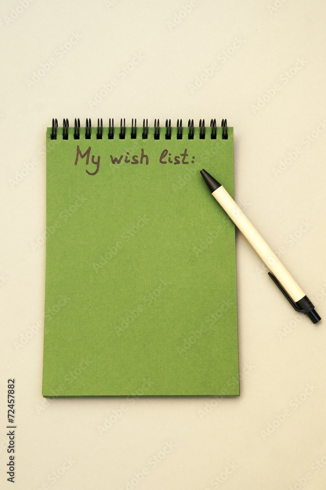 Hand drawing wish list on notebook Hand drawing wish list on notebook