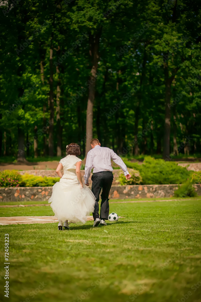 beautiful the couple in wedding day playing football beautiful the couple in wedding day playing football