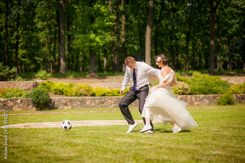 beautiful the couple in wedding day playing football