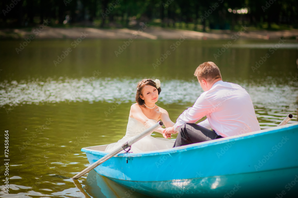 beautiful newlyweds in wedding day in a boat beautiful newlyweds in wedding day in a boat