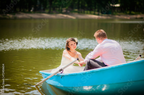 beautiful newlyweds in wedding day in a boat