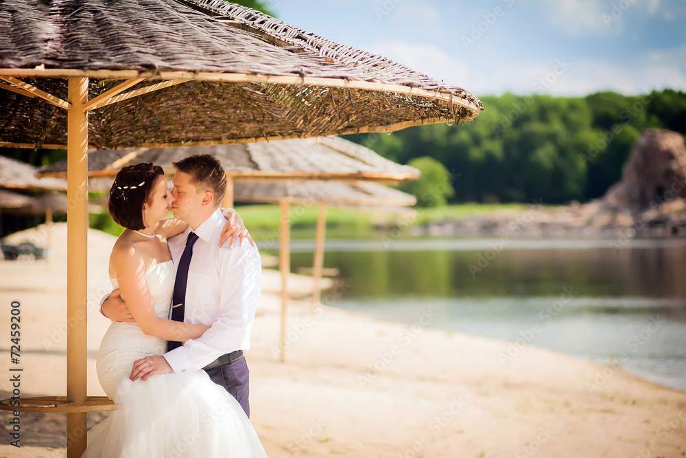 beautiful newlyweds in wedding day on the lake