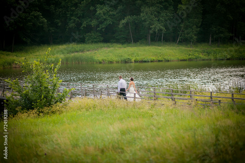 beautiful newlyweds in wedding day on the bridge