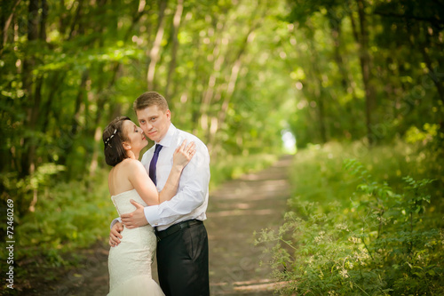 beautiful newlyweds in wedding day in the woods