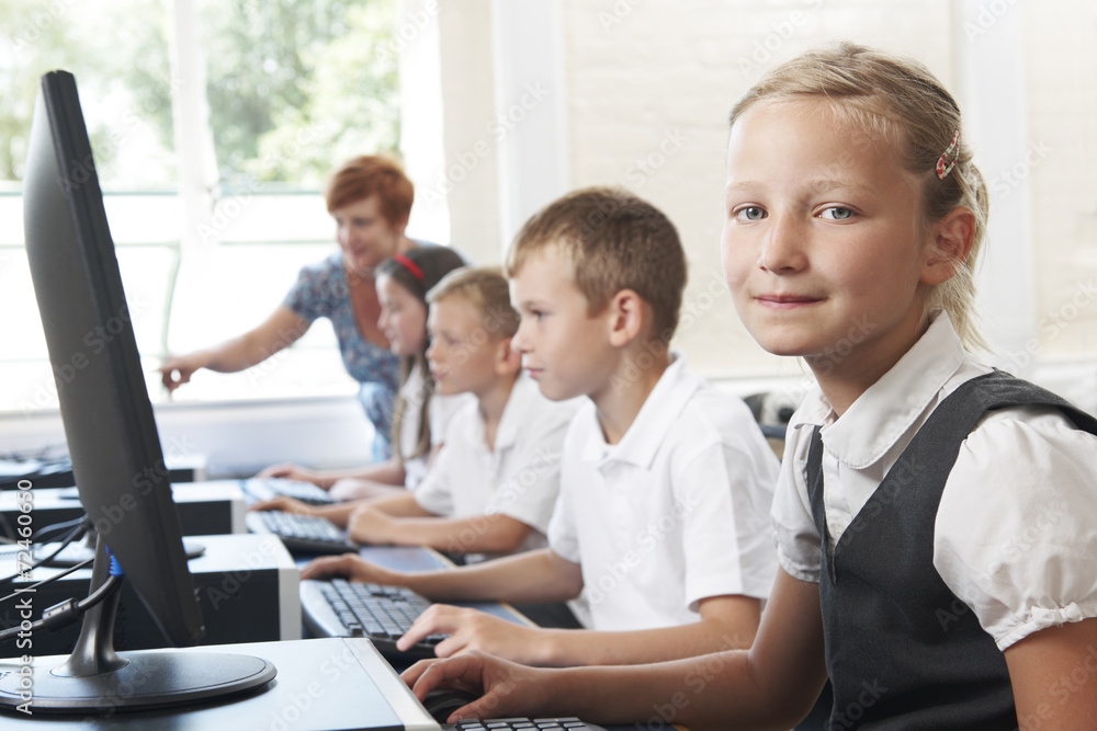 Group Of Elementary Pupils In Computer Class With Teacher Group Of Elementary Pupils In Computer Class With Teacher