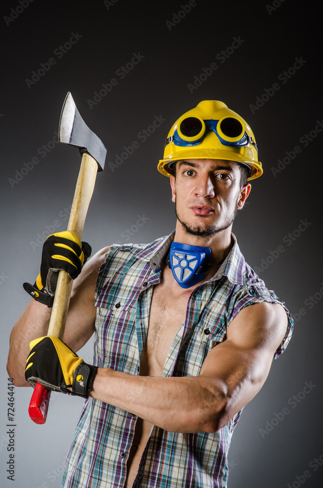 Ripped muscular builder man with tools Ripped muscular builder man with tools
