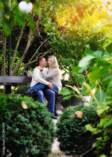 loving couple on a bench in autumn park