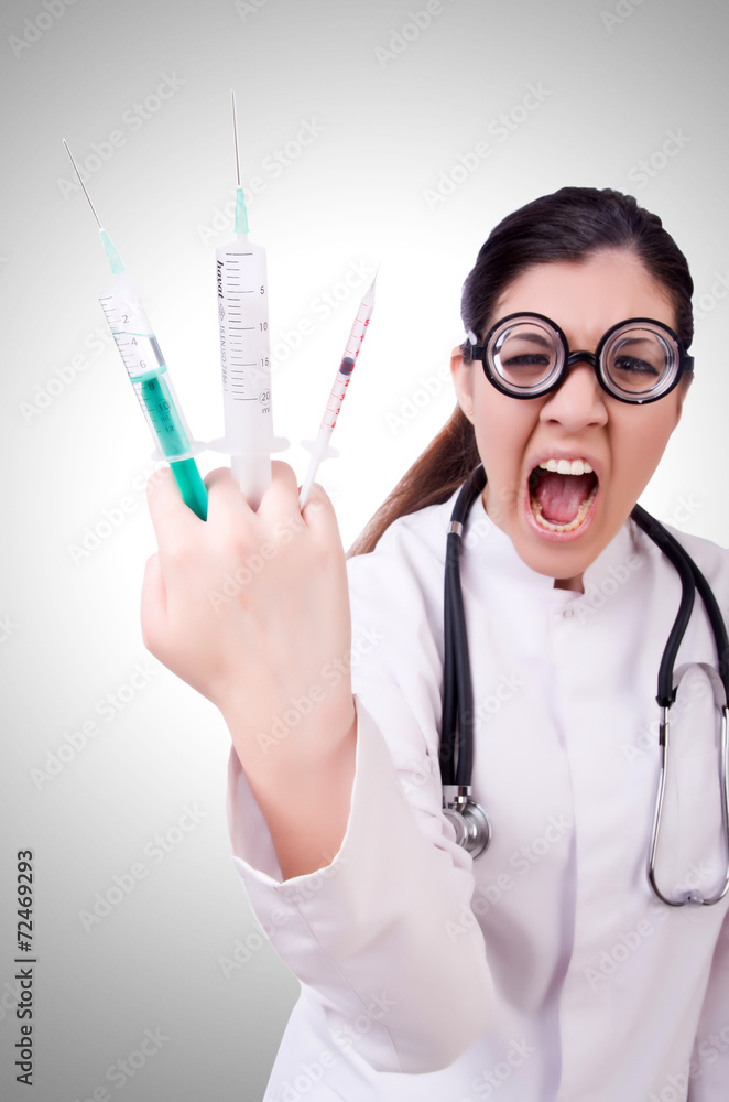 Woman doctor with syringe on white Woman doctor with syringe on white