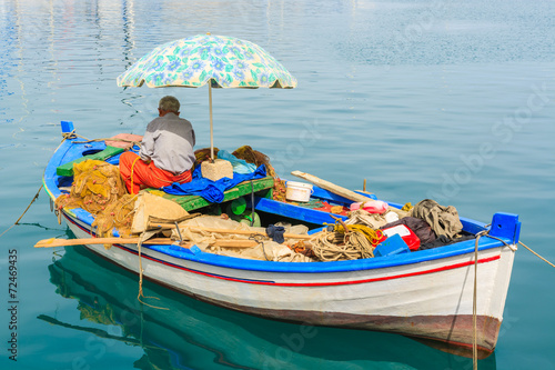 Photos Fisherman in fishing boat in Sami port, Kefalonia island, Greece