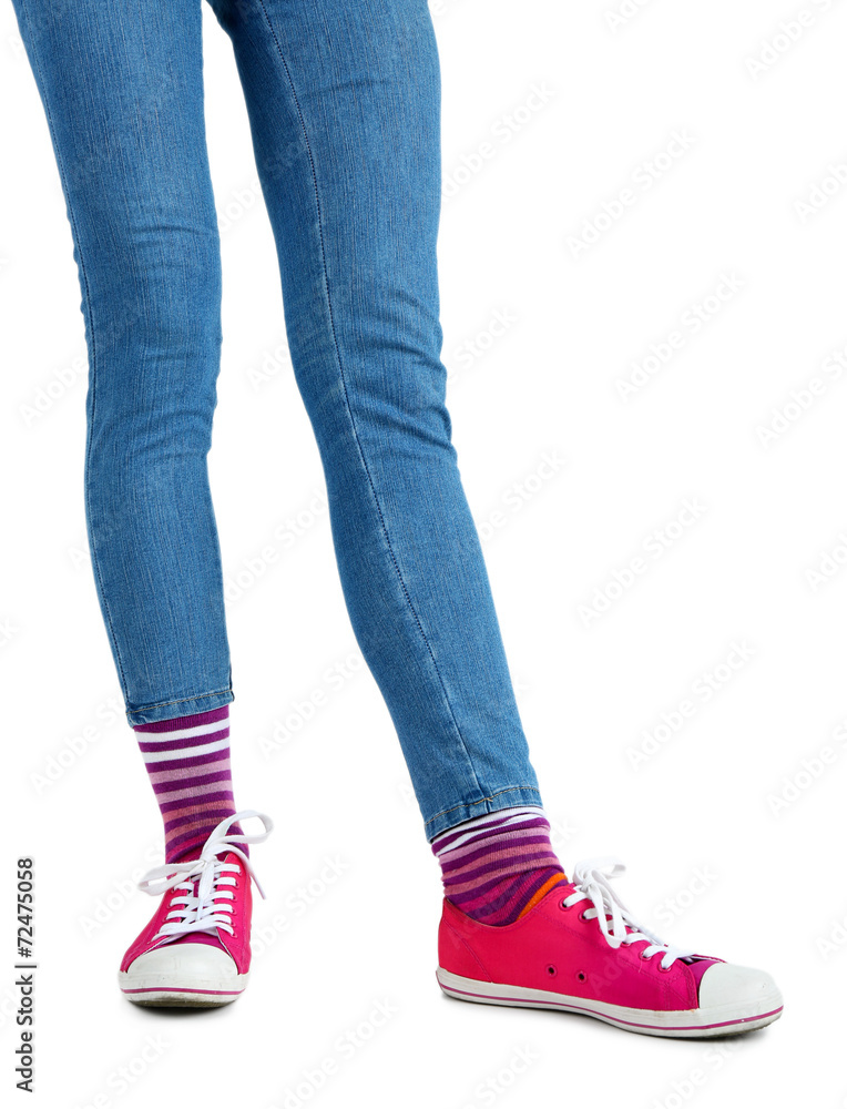 Female legs in colorful socks and sneakers isolated on white Female legs in colorful socks and sneakers isolated on white