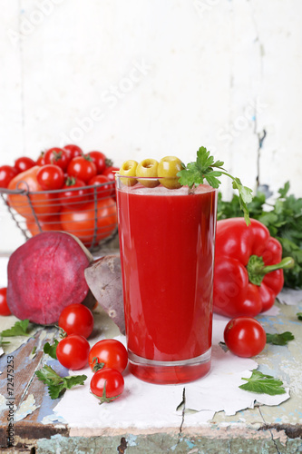 Glass of tomato juice and fresh vegetables