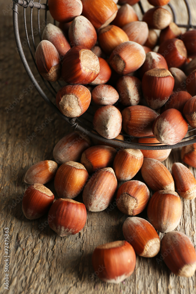 Hazelnuts in basket on wooden background Hazelnuts in basket on wooden background