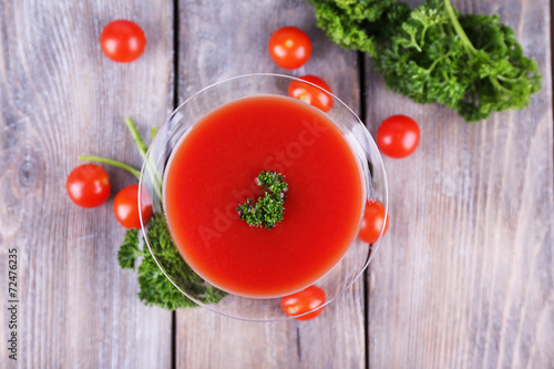 Tomato juice in goblet, parsley and fresh tomatoes