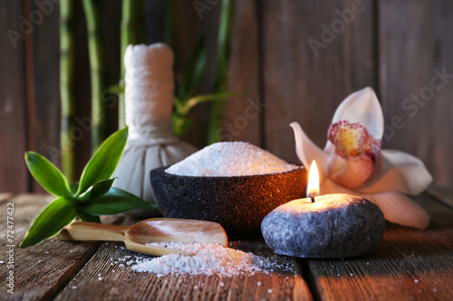 Spa set on wooden surface on wooden wall background