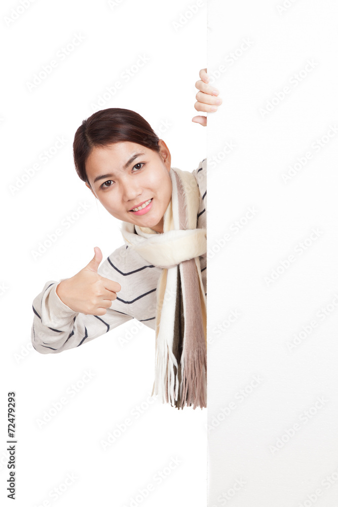 Asian girl with scarf peeking from behind blank sign thumbs up Asian girl with scarf peeking from behind blank sign thumbs up