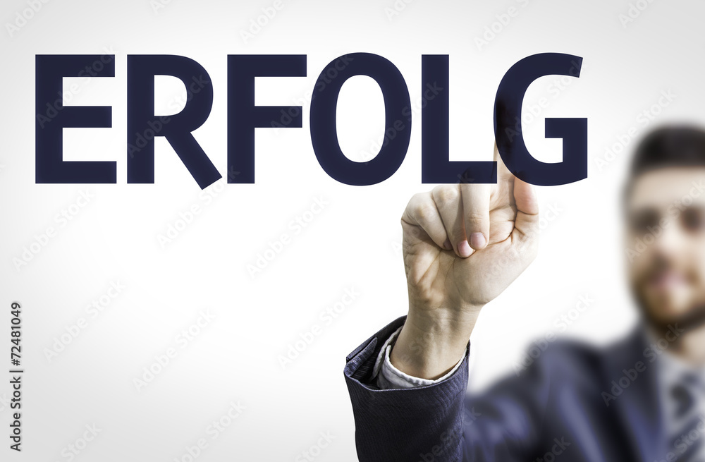 Business man pointing the text: Success (In German) Business man pointing the text: Success (In German)