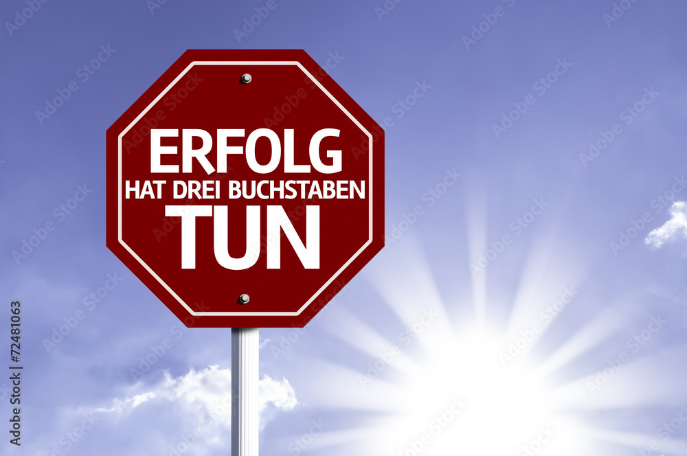 Success Has To Do Three Letters (In German) written on red road Success Has To Do Three Letters (In German) written on red road