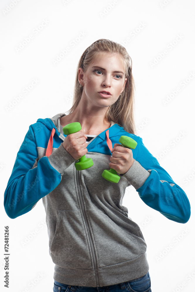 The girl with dumbbells on a white background The girl with dumbbells on a white background