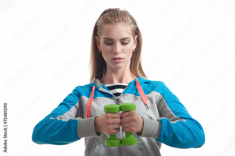 The girl with dumbbells on a white background The girl with dumbbells on a white background