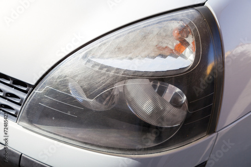 Scratched car headlight © tomispin