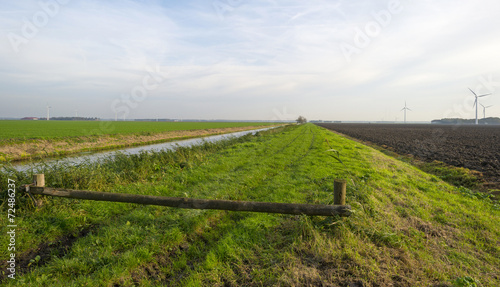 Closed footpath along a canal in autumn