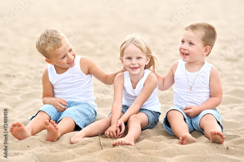 Portrait of children on the beach in summer