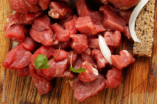 beef cut into cubes on a wooden background
