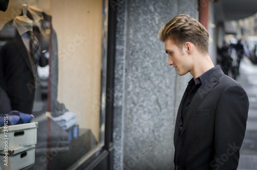 Young Man Looking at Fashion Items in Shop Window © theartofphoto