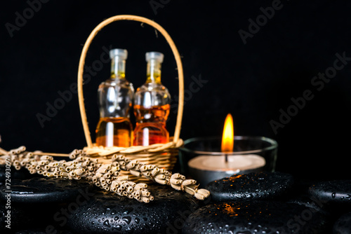 Aromatic spa concept of bottles essential oil in basket, dried l